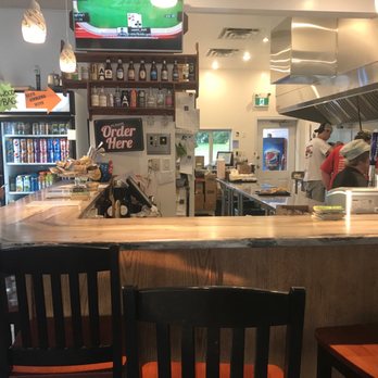 Herbert Fisheries - a man standing at the counter of a restaurant - Fish & Chips Near Me - Killarney, Ontario
