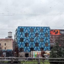 Portland Streetcar Stop 2167 - Don'miss the Street Art whenever you ride. Oh, Portland! The Artist signed on tge bldg nxt door