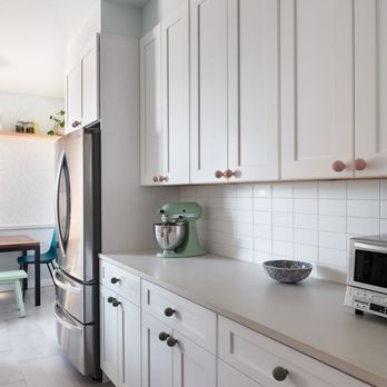 Apex Remodeling - a kitchen with white cabinets and appliances - General Contractors Near Me Apex Remodeling - a kitchen with white cabinets and appliances - General Contractors Near Me