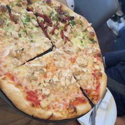 Pesto chicken pizza and cheese and chicken pizza (half-n-half)