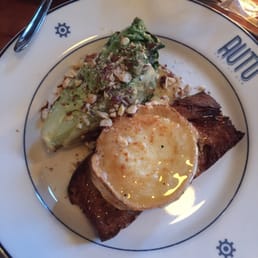 Baked goats cheese with caramel sauce and baked lettuce on toast with some hazelnut Baked goats cheese with caramel sauce and baked lettuce on toast with some hazelnut