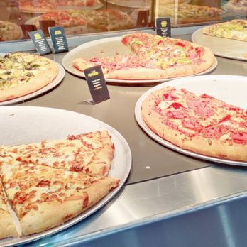Yummy Slice Pizza - The display of pizzas on the warmer by the slice - Pizza Near Me - Richmond, British Columbia Yummy Slice Pizza - The display of pizzas on the warmer by the slice - Pizza Near Me - Richmond, British Columbia