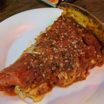 Rosati's Pizza - A single slice of pepperoni and onion deep dish pizza, covered in parmesan and red pepper flakes. - Pizza Near Me - Encinitas, California