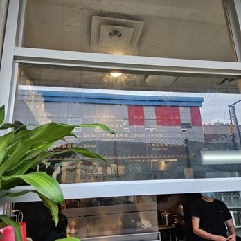 HanHan Noodle House - a man standing in front of a window - Chinese Near Me - Flushing, New York HanHan Noodle House - a man standing in front of a window - Chinese Near Me - Flushing, New York