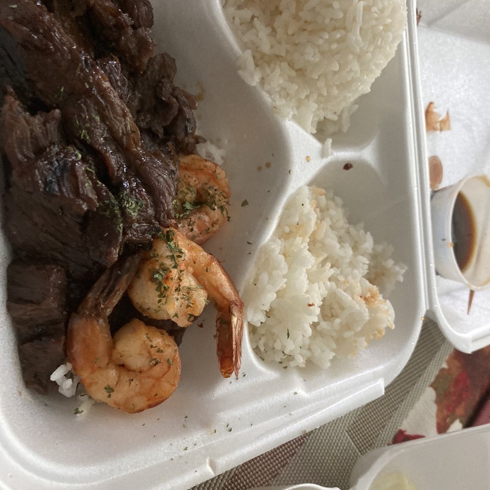 a tray of food with rice, meat, and vegetables a tray of food with rice, meat, and vegetables