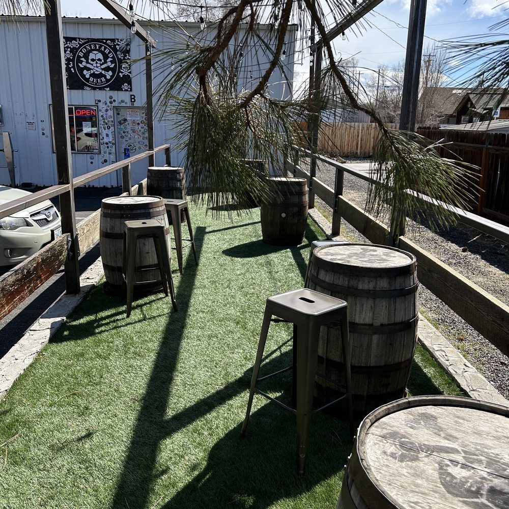 a row of wooden barrels and tables a row of wooden barrels and tables