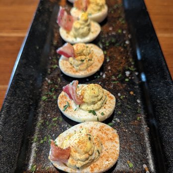 J. Alexander's - I loved these morsels of deliciousness. Deviled eggs with the hint of pickles, topped with bacon. - New American Near Me - Livonia, Michigan