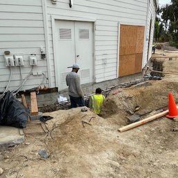 Workers placing structural steel for grade beam