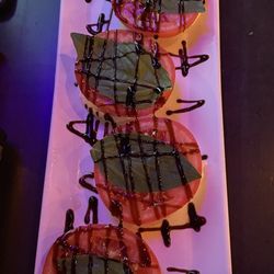 The Growler Garage - Appetizer Mozzarella, tomato, basil leaf sprinkled with balsamic vinegar $12.00
