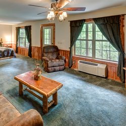 Lake Forest Luxury Log Cabins - Eureka Springs Cabins, Lower level features Living Room with Qu. Sofa Sleeper & Queen bed open setting, and separate bedroom with Qu.& BR.