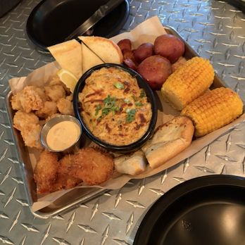 Mad Beach Craft Brewing - Platter with fried grouper, coconut shrimp, crab dip. Potatoes, and corn - Breweries Near Me - Madeira Beach, Florida