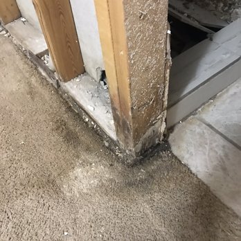 Honey Do - the corner of a room with a hole in the wall - Landscaping Near Me