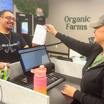 Organic Farms - Staff serving a customer at Organic Farms cannabis dispensary - Cannabis Dispensaries Near Me - Camden, New Jersey Organic Farms - Staff serving a customer at Organic Farms cannabis dispensary - Cannabis Dispensaries Near Me - Camden, New Jersey
