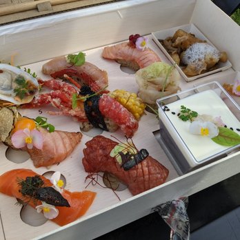 Laughing Monk Cafe - Close up of the takeout omakase box, with 11 courses. - Sushi Bars Near Me - Boston, Massachusetts Laughing Monk Cafe - Close up of the takeout omakase box, with 11 courses. - Sushi Bars Near Me - Boston, Massachusetts