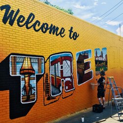 Tremont Convenience Mart - New mural being painted on the side of the store!