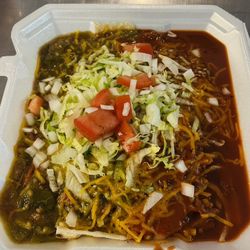 Our FAMOUS Huevos Rancheros topped RED & GREEN CHILE with Garnish & onions!