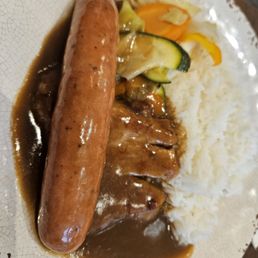 Pork chop and German sausage on rice Pork chop and German sausage on rice