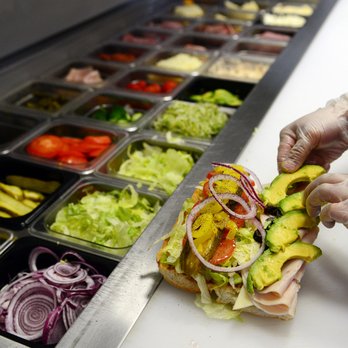 Deli Delicious - a person preparing a sandwich - Delis Near Me - Pixley, California