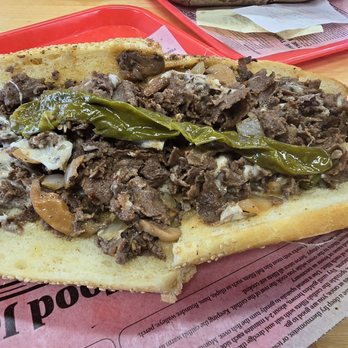 Johnny Longhots Steaks - Cheesesteak with onions, mushrooms, Cooper Sharp, longhots, and hot peppers on a Liscio's seeded roll. - Cheesesteaks Near Me - Wildwood, New Jersey Johnny Longhots Steaks - Cheesesteak with onions, mushrooms, Cooper Sharp, longhots, and hot peppers on a Liscio's seeded roll. - Cheesesteaks Near Me - Wildwood, New Jersey