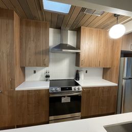 Brown cabinets, quartz counter top, tiles Brown cabinets, quartz counter top, tiles