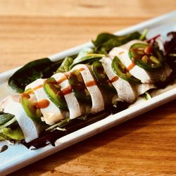 Wasabi Japanese Grill & Bar - Hamachi Jalapeños; aka Yellow Tail, jalapeños, ponzu, siracha sauce.  Stacked over spinach salad.  Very good.