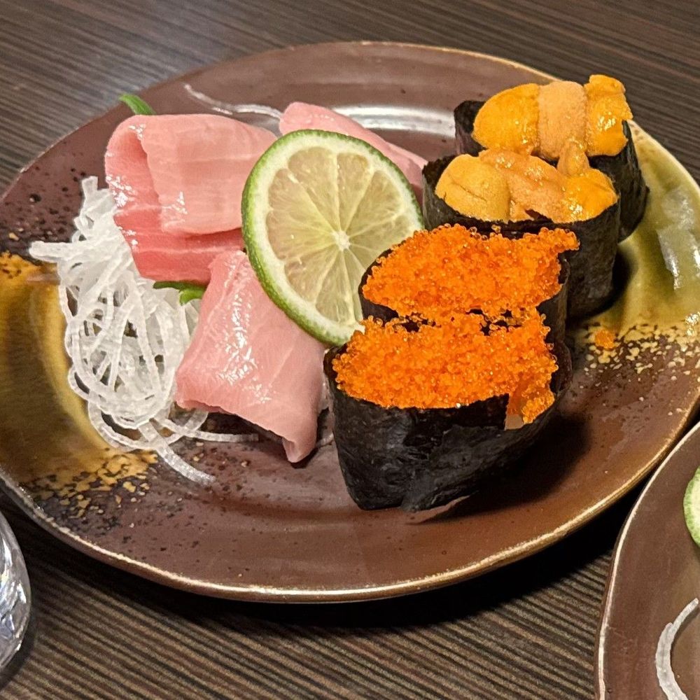 Blue Fin Toro sashimi, uni nigiri, and tobiko nigiri Blue Fin Toro sashimi, uni nigiri, and tobiko nigiri
