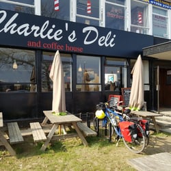 Charlie's Deli & Coffee House - Table outside but it's a little bit muddy