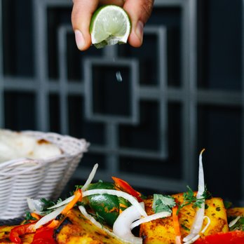 Hyderabad Biryani House - a hand sprinkling a lime over a plate of food - Indian Near Me - Vancouver, British Columbia Hyderabad Biryani House - a hand sprinkling a lime over a plate of food - Indian Near Me - Vancouver, British Columbia