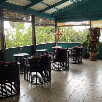Wild Ginger Hotel - The open air lobby/common area with tables set-up for breakfast or an afternoon break. - Hotels Near Me - Hilo, Hawaii