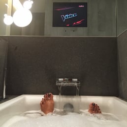 Watching TV in the tub after a long flight.