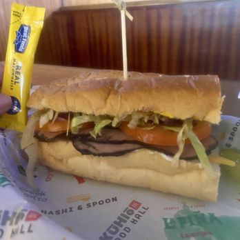 Hawaii Hoagie - 5/22/26 Roast Beef sandwich and a banana pickle  mayonnaise packet held for measurement on size. 6inch sandwich - Sandwiches Near Me - Honolulu, Hawaii