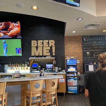 Wings and Rings - a woman watching tv in a bar - Chicken Wings Near Me - Danville, Kentucky Wings and Rings - a woman watching tv in a bar - Chicken Wings Near Me - Danville, Kentucky