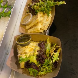 two burritos with lettuce and salsa