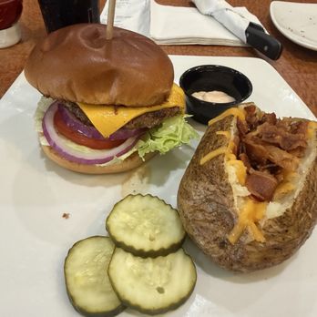 Sizzler - The burger with a baked potato. It's edible but nothing special and I did not appreciate the potato costing extra four dollars. - Seafood Near Me - Torrance, California Sizzler - The burger with a baked potato. It's edible but nothing special and I did not appreciate the potato costing extra four dollars. - Seafood Near Me - Torrance, California