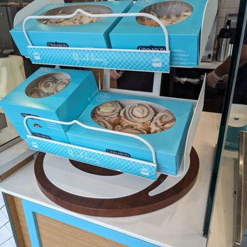 Cinnabon - a display of donuts in blue boxes - Bakeries Near Me - Elk Grove, California