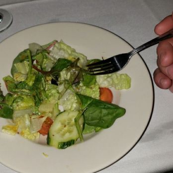 Signatures Restaurant - a person eating a salad with a fork - Italian Near Me - Waterbury, Connecticut Signatures Restaurant - a person eating a salad with a fork - Italian Near Me - Waterbury, Connecticut