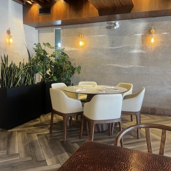 Essence Bistro - a table and chairs in a restaurant - Latin American Near Me - Vaughan, Ontario Essence Bistro - a table and chairs in a restaurant - Latin American Near Me - Vaughan, Ontario