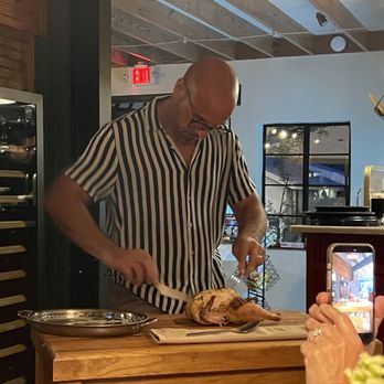 Bottega Salaria - The Owner, Valerio carving the roasted chicken tableside. - Italian Near Me - Fredericksburg, Texas