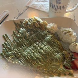 Fruit crepe with pistachio drizzle.