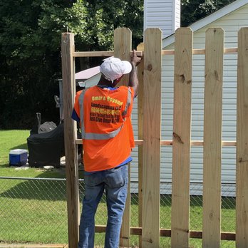 Omar And Beyond Landscaping - a man working on a fence - Landscaping Near Me Omar And Beyond Landscaping - a man working on a fence - Landscaping Near Me