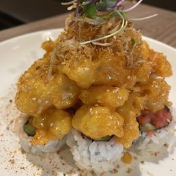 Rock crab roll! Fried rock crab with a light honey taste with the perfect crunch atop fresh spicy tuna rolls! The absolute Perfect Bite!