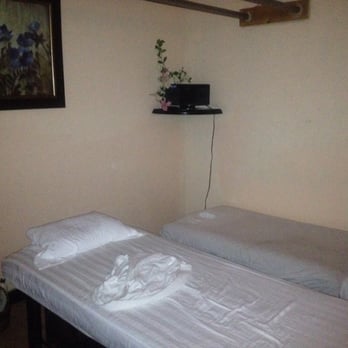 At Ease Massage - There's another bed behind me that you can't see. This was after my massage, and I wax the only one in there. Good-sized room. - Massage Near Me - Hesperia, California