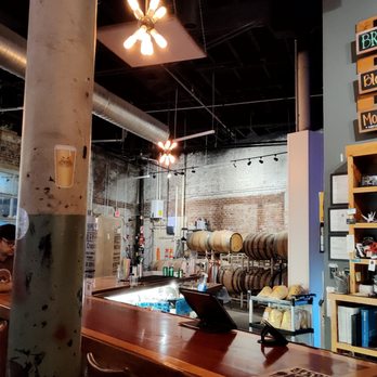 Joymongers Barrel Hall - An industrial vibe, with wooden legs in the background - Brewpubs Near Me - Winston-Salem, North Carolina