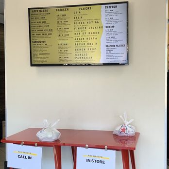 Fry Daddys - two red tables in front of a menu - Chicken Wings Near Me - Dallas, Texas Fry Daddys - two red tables in front of a menu - Chicken Wings Near Me - Dallas, Texas