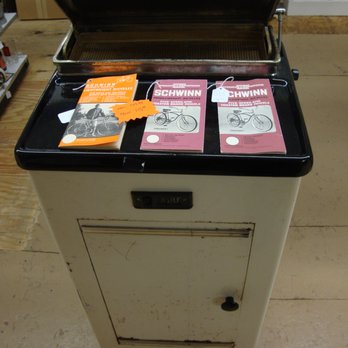 Treasures Under Sugar Loaf - Antique sterilizer with vintage Schwinn manuals displayed on top. - Antiques Near Me - Winona, Minnesota