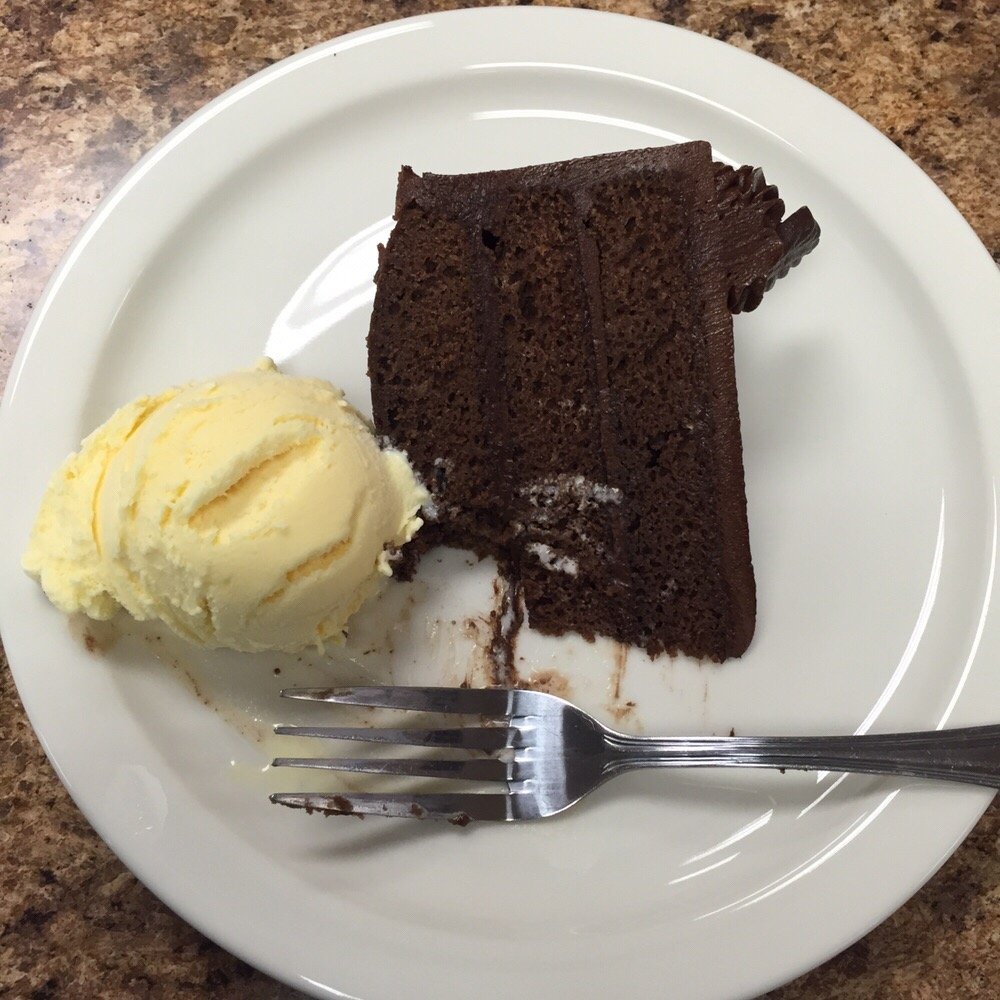 A slice of Devil's Delight cake that came with a free scoop of ice cream. Sorry for the bite, but I couldn't wait to try it. A slice of Devil's Delight cake that came with a free scoop of ice cream. Sorry for the bite, but I couldn't wait to try it.