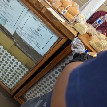 Manny's Bakeshop & Restaurant - pastries all pre-packaged along the top of their wooden display cases. Balintawak on left and Pianomo Rolls on right... 7.5.22 - Bakeries Near Me - Waipahu, Hawaii