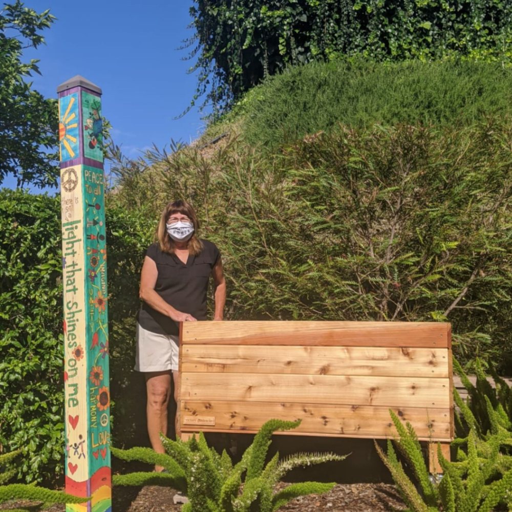 My mom with her new planter box! There's definitely a smile under that mask. My mom with her new planter box! There's definitely a smile under that mask.