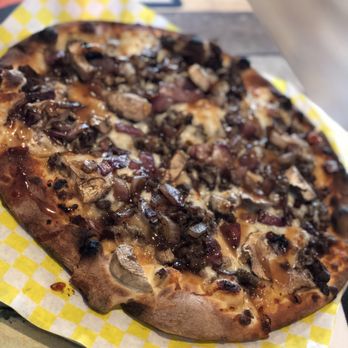Docksiders Pub & Oven - a pizza on a table - Pizza Near Me - Hilton, New York Docksiders Pub & Oven - a pizza on a table - Pizza Near Me - Hilton, New York