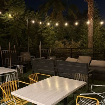 Escape Craft Brewery - Lots of different ways to hang out - relax on the outdoor patio surrounded by palm trees - Breweries Near Me - Redlands, California